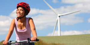 Woman biking / wind turbine