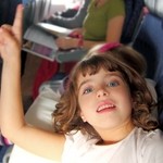 little girl inside aircraft rising up finger