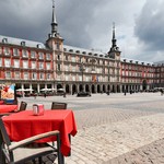 Cafe tables with red tableclothes in Plaza Mayor. Madrid.