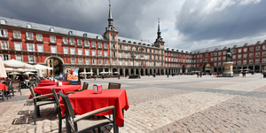 Cafe tables with red tableclothes in Plaza Mayor. Madrid.
