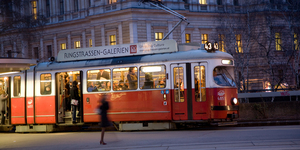 Red old trolley car in Vienna in the first District by night
